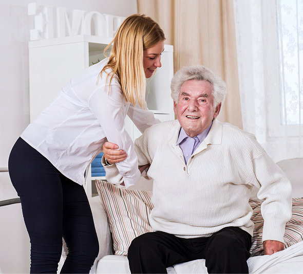 a caregiver assisting her patient sitting down