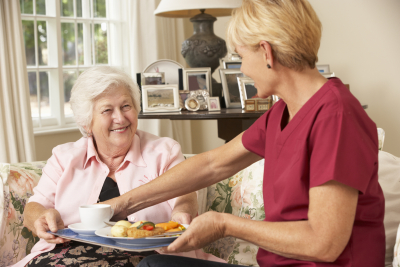 woman giving senior food